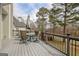 Outdoor deck furnished with a dining set, umbrella, and a view of trees in the background at 2510 Shoreline Pkwy, Villa Rica, GA 30180