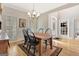 Formal dining room with hardwood floors, chandelier, and adjacent doorway at 2510 Shoreline Pkwy, Villa Rica, GA 30180