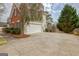 Brick and siding two story home with an attached two car garage and driveway at 2510 Shoreline Pkwy, Villa Rica, GA 30180