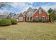 Well-manicured lawn and landscaping of the charming brick two-story home at 2510 Shoreline Pkwy, Villa Rica, GA 30180