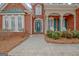 Close-up of inviting brick home with a blue front door and lovely front garden at 2510 Shoreline Pkwy, Villa Rica, GA 30180