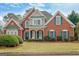 Charming brick home with lush landscaping, well-manicured lawn, and inviting front entrance at 2510 Shoreline Pkwy, Villa Rica, GA 30180
