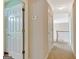 Light and airy carpeted hallway with white doors, trim, and staircase at 2510 Shoreline Pkwy, Villa Rica, GA 30180