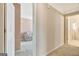 Neutral hallway with doorways to the living room and bathroom showcasing an open floor plan at 2510 Shoreline Pkwy, Villa Rica, GA 30180