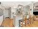 Well-lit kitchen with white cabinets, granite countertops, and an island with bar seating at 2510 Shoreline Pkwy, Villa Rica, GA 30180