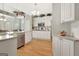 Bright kitchen featuring white cabinets, stainless steel appliances, and hardwood floors at 2510 Shoreline Pkwy, Villa Rica, GA 30180