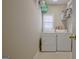 Functional laundry room with washer, dryer, shelving, and a window for natural light at 2510 Shoreline Pkwy, Villa Rica, GA 30180