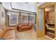 Living room with leather sofas, mini fridge, and door leading to sauna at 2510 Shoreline Pkwy, Villa Rica, GA 30180