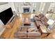 Bright and airy living room with hardwood floors, a stone fireplace, and ample seating at 2510 Shoreline Pkwy, Villa Rica, GA 30180
