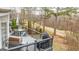 Relaxing outdoor deck featuring a grill and a dining table, overlooking scenic backyard views at 2510 Shoreline Pkwy, Villa Rica, GA 30180