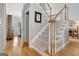 Carpeted staircase with white railing, hardwood floors, and a view to the dining room at 2510 Shoreline Pkwy, Villa Rica, GA 30180