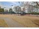 Well-maintained community tennis court with fencing, and a pathway at 2510 Shoreline Pkwy, Villa Rica, GA 30180