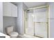 Bright bathroom with a walk-in shower and updated shower head; ample storage above toilet at 1067 Pinehurst Dr, Peachtree City, GA 30269