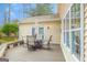Exterior shot showcasing the back deck with outdoor dining set and shaded seating area at 1067 Pinehurst Dr, Peachtree City, GA 30269