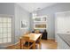 Cozy dining room with natural light, stylish lighting fixture, and a view into the kitchen at 1067 Pinehurst Dr, Peachtree City, GA 30269