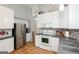 Bright kitchen features stainless steel appliances and modern finishes at 1067 Pinehurst Dr, Peachtree City, GA 30269