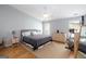 Large bedroom with hardwood floors, a ceiling fan, neutral color palette, and natural light at 1067 Pinehurst Dr, Peachtree City, GA 30269