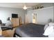 Bedroom with hardwood floors, TV, exercise bike, and view to en suite bathroom at 1067 Pinehurst Dr, Peachtree City, GA 30269
