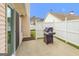 Exterior patio view with a grill, privacy fence, and sliding glass door at 1067 Pinehurst Dr, Peachtree City, GA 30269