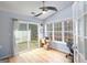 Bright sunroom with hardwood floors, ceiling fan, and sliding door access to the outdoors at 1067 Pinehurst Dr, Peachtree City, GA 30269