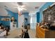 Eclectic bedroom with blue walls and unique decor, featuring a ceiling fan and natural light at 1561 Aiken Chafin Ln, Mcdonough, GA 30252