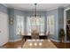 Dining room with granite counter, hardwood floors, and bright windows with shutters at 1561 Aiken Chafin Ln, Mcdonough, GA 30252