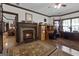 Comfortable home office with stone fireplace, built-in desk, and natural light from the window at 1561 Aiken Chafin Ln, Mcdonough, GA 30252