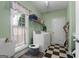 Bright laundry room with checkered floors and window at 1561 Aiken Chafin Ln, Mcdonough, GA 30252