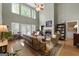 Living room with fireplace, tall windows, and a neutral color palette at 1561 Aiken Chafin Ln, Mcdonough, GA 30252