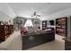 Large living room featuring a ceiling fan, a TV, and built-in bookshelves at 1561 Aiken Chafin Ln, Mcdonough, GA 30252