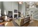 Cozy living room with tall ceilings, a fireplace, hardwood floors, and a staircase view at 1561 Aiken Chafin Ln, Mcdonough, GA 30252