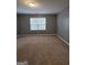 Bedroom featuring neutral walls, carpet, and a window providing natural light at 1463 River Stone Trce, Conyers, GA 30012