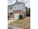 Side view of the townhome, showcasing the brick and siding design and well-maintained landscape at 1463 River Stone Trce, Conyers, GA 30012