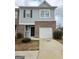 Charming townhome featuring a brick and siding exterior with an attached single car garage at 1463 River Stone Trce, Conyers, GA 30012