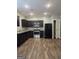 Well-equipped kitchen featuring dark cabinets, stainless steel appliances, and modern granite countertops at 1463 River Stone Trce, Conyers, GA 30012