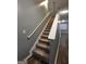 Interior staircase with carpeted steps and a white handrail at 1463 River Stone Trce, Conyers, GA 30012