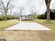 Single-story home with concrete pad and spacious yard surrounded by mature trees at 299 Lagrange St, Grantville, GA 30220