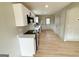 Well-lit kitchen featuring stainless steel appliances, white cabinets, and a convenient layout at 299 Lagrange St, Grantville, GA 30220