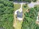 Aerial view of a luxury home with a circular driveway surrounded by trees at 4233 Sandstone Shores Dr, Stonecrest, GA 30038