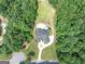 Overhead view of the home on a large lot with mature trees and an in-ground pool at 4233 Sandstone Shores Dr, Stonecrest, GA 30038