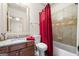 Cozy bathroom with granite counters, tub with shower, and a large mirror at 4233 Sandstone Shores Dr, Stonecrest, GA 30038