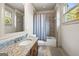 Bright bathroom features granite counters, a tub-shower combo, and natural light at 4233 Sandstone Shores Dr, Stonecrest, GA 30038