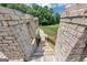 Stairway descending through brick pillars and ornate metal railings to the backyard at 4233 Sandstone Shores Dr, Stonecrest, GA 30038