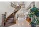 Grand foyer featuring a curved staircase, soaring ceilings, and elegant finishes at 4233 Sandstone Shores Dr, Stonecrest, GA 30038