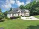 Beautiful two-story home with a circular driveway and manicured landscaping at 4233 Sandstone Shores Dr, Stonecrest, GA 30038