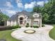 Beautiful two-story home with a circular driveway and manicured landscaping at 4233 Sandstone Shores Dr, Stonecrest, GA 30038