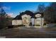 Beautiful two-story home with a circular driveway and manicured landscaping at 4233 Sandstone Shores Dr, Stonecrest, GA 30038