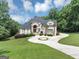 Beautiful two-story home with a circular driveway and manicured landscaping at 4233 Sandstone Shores Dr, Stonecrest, GA 30038