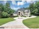 Beautiful two-story home with a circular driveway and manicured landscaping at 4233 Sandstone Shores Dr, Stonecrest, GA 30038