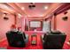 A plush home theater showcasing reclining chairs, and a high-definition screen, promising an immersive cinematic experience at 4233 Sandstone Shores Dr, Stonecrest, GA 30038